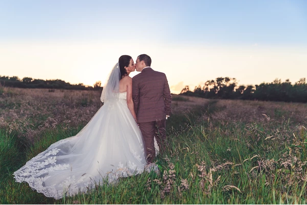 wedding photography by j lawrence bride and groom in field